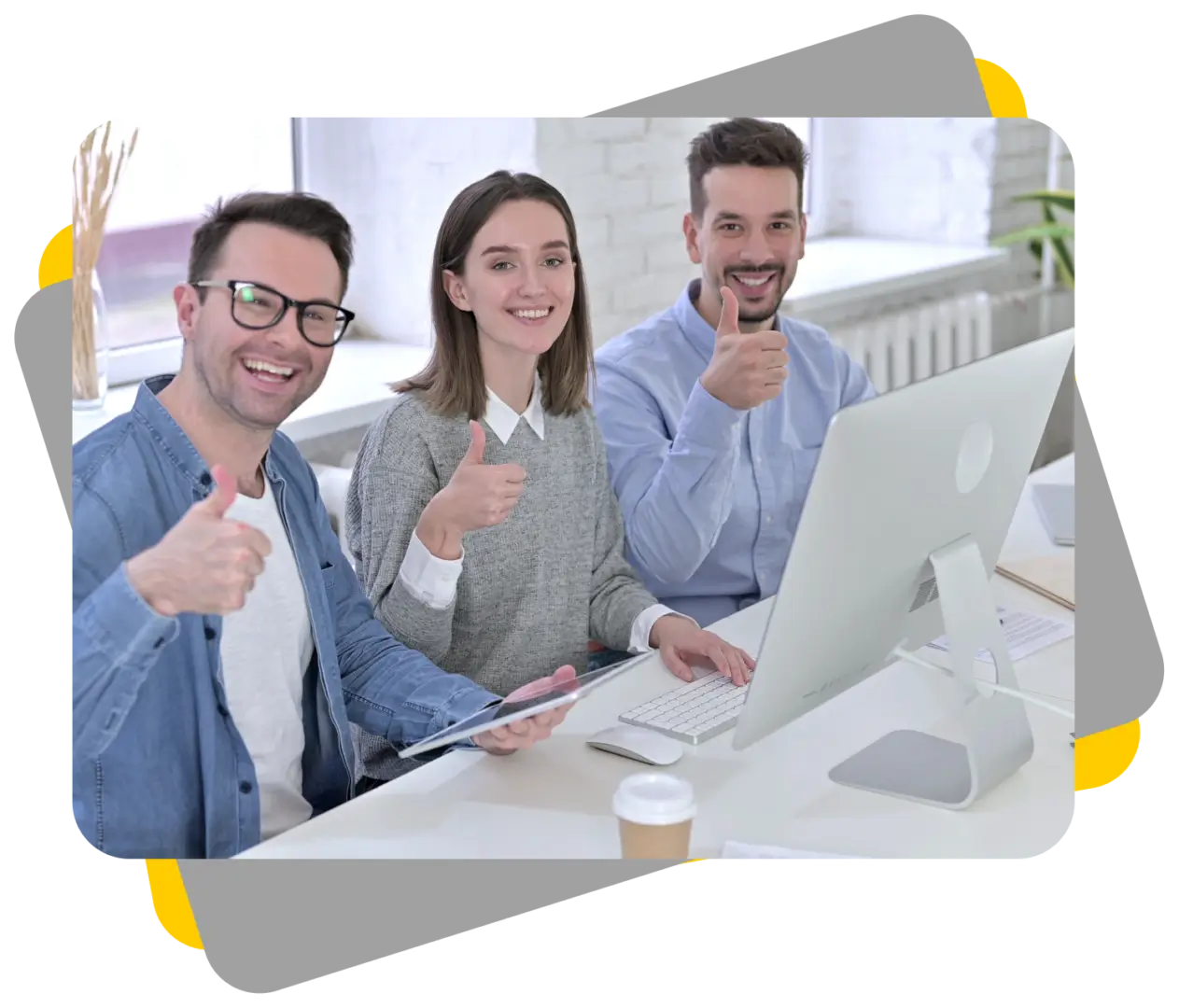 Three people sitting at a table with a laptop